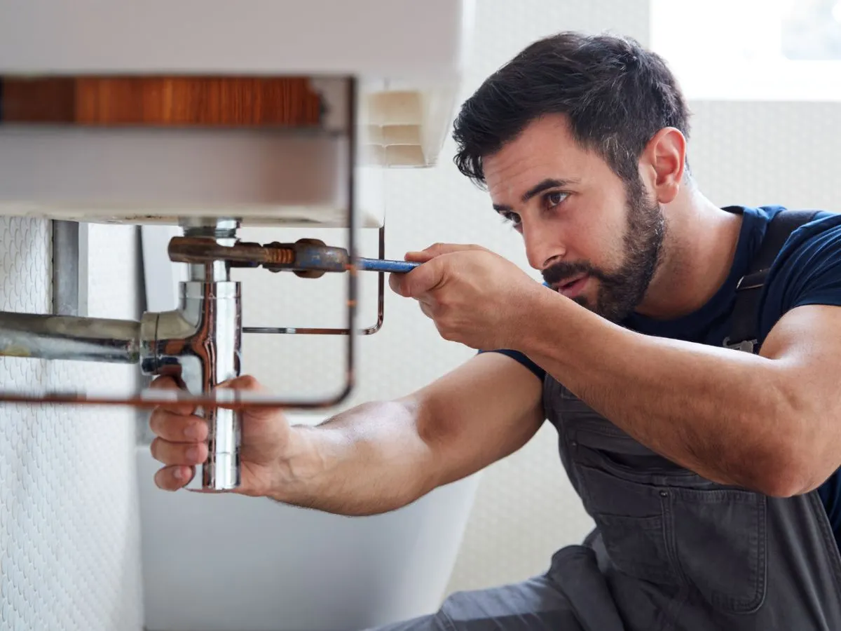 a man fixing a sink