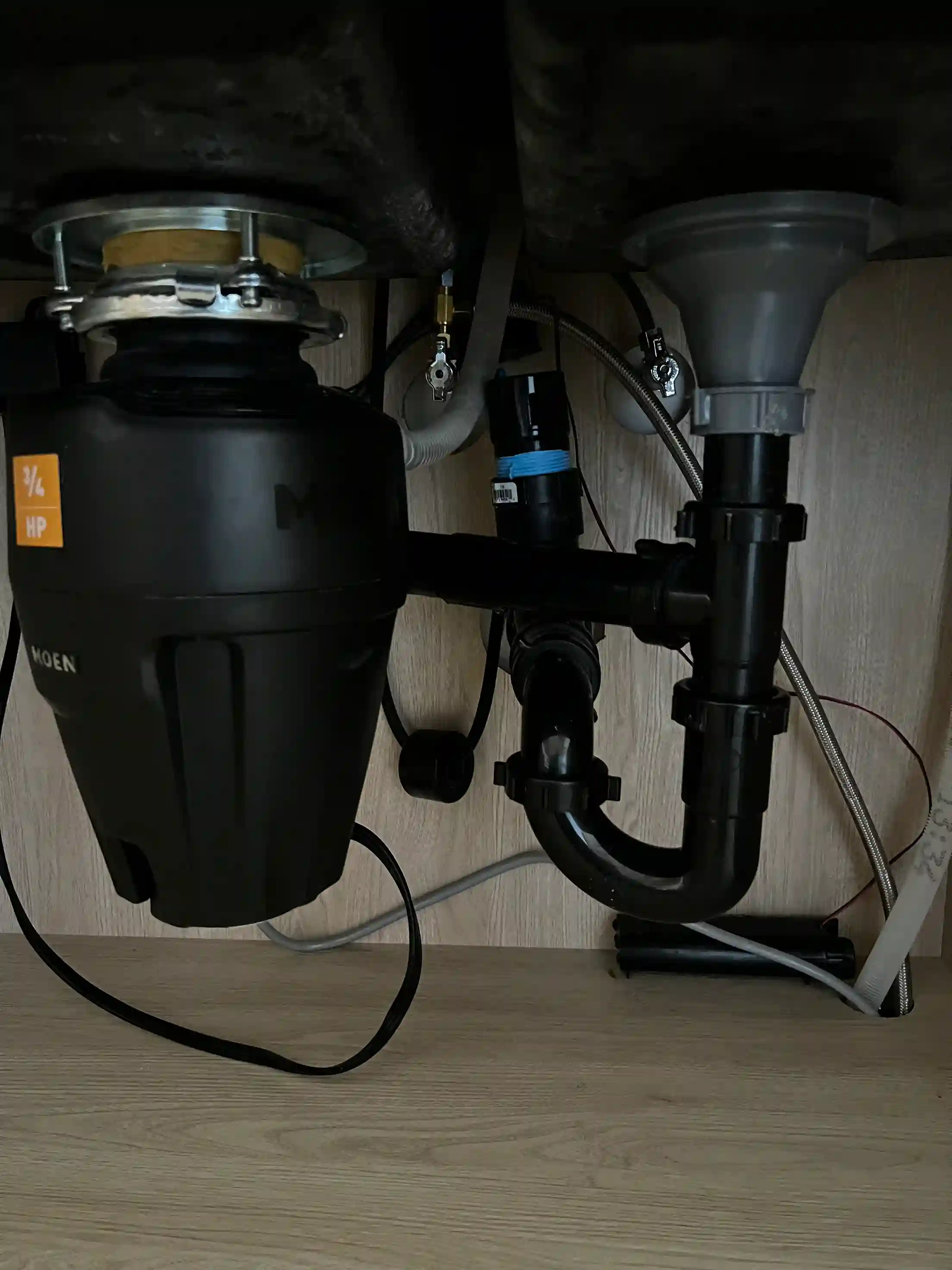 Modern garbage disposal machine installed under kitchen sink
