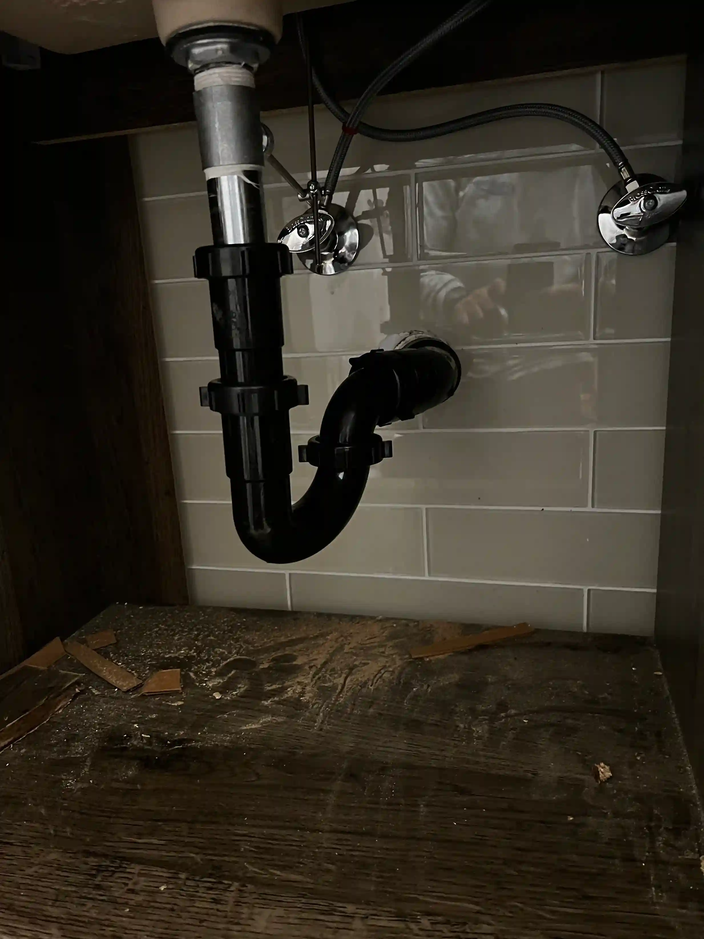 Checking under sink for drainage cleaning