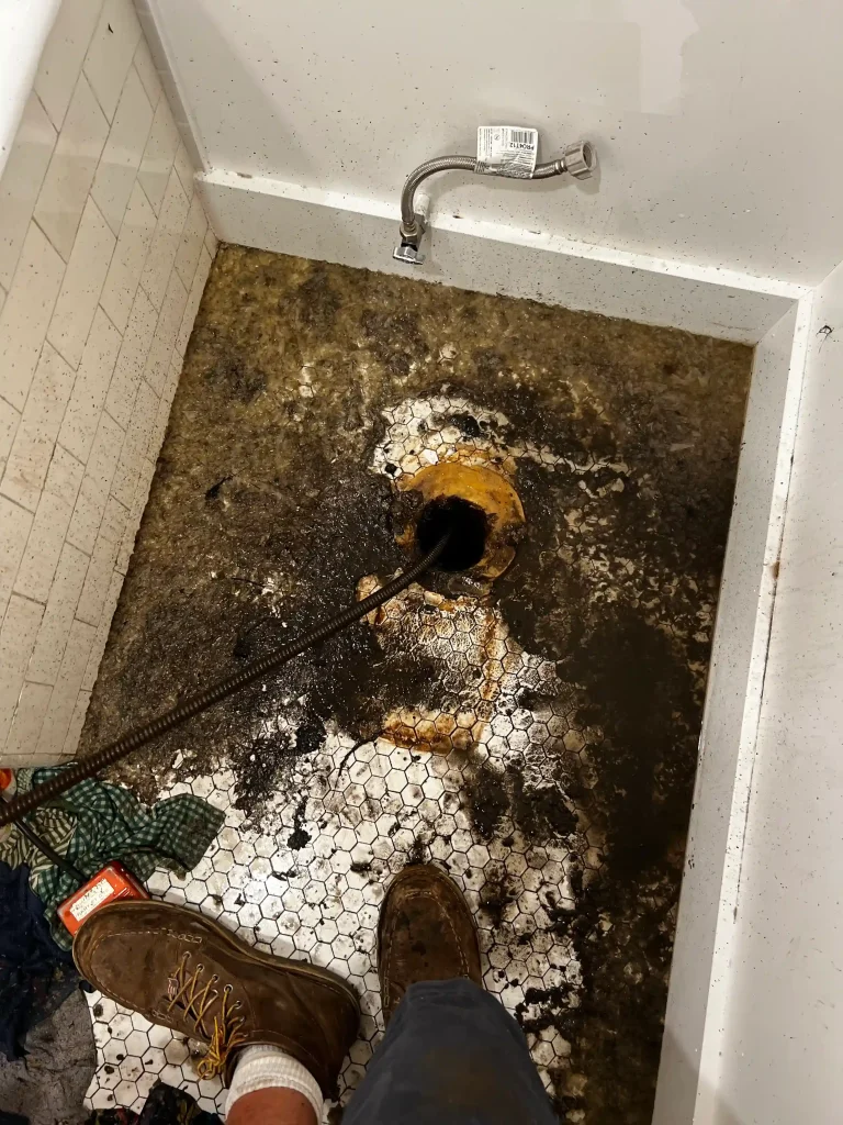 Pulling the toilet and floor drain to clear the blockage